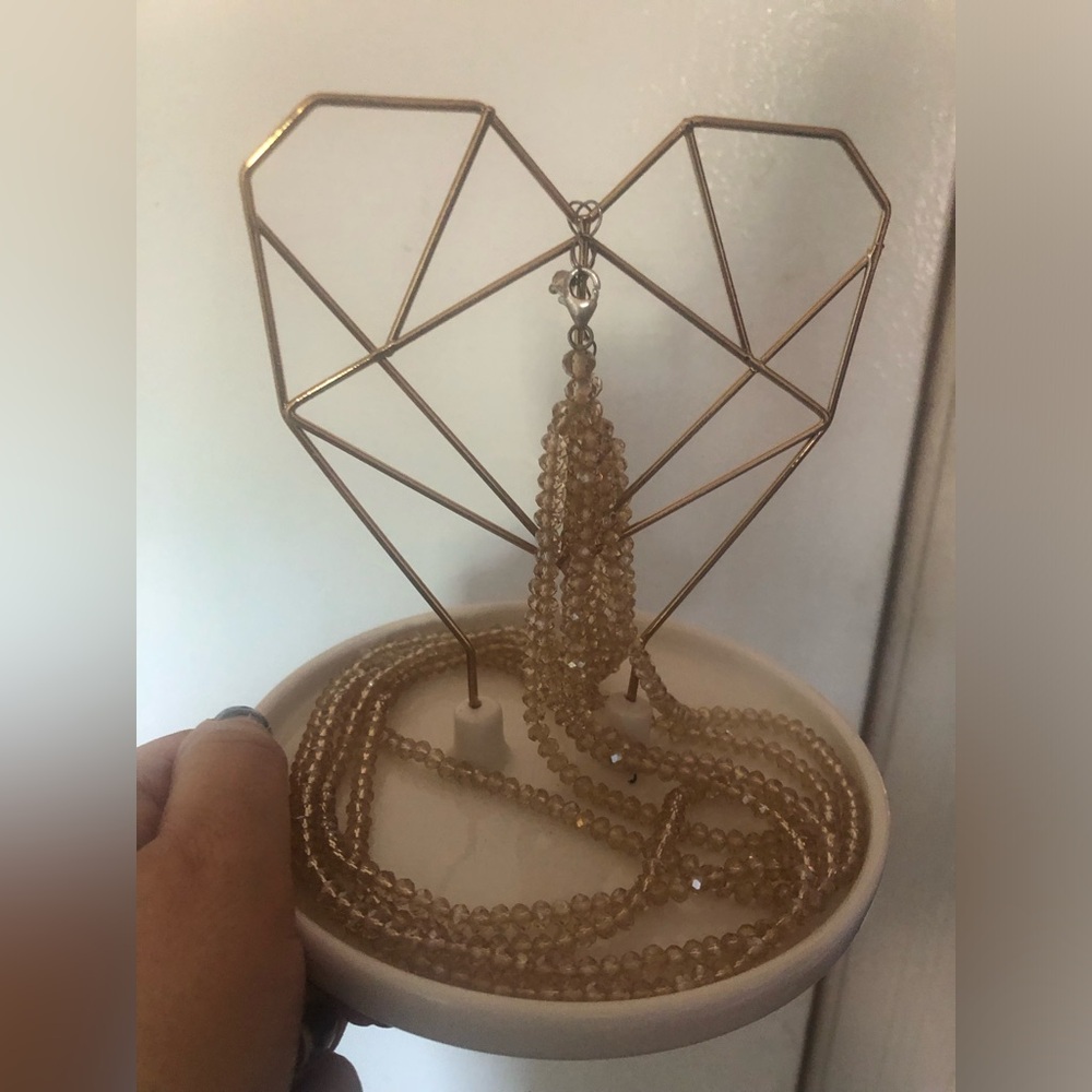 Heart shaped copper wire and ceramic jewlery holder or decoration.
